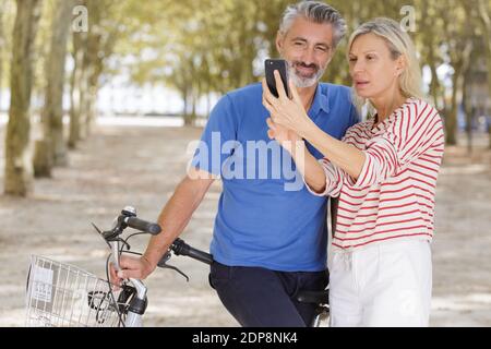 Glückliches Seniorenpaar, das ein Selfie mit Fahrrädern macht Stockfoto