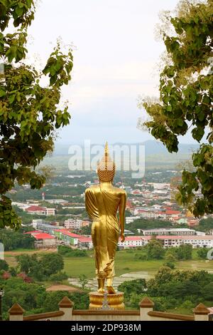 Das 9 Meter hohe goldene Buddha-Bild in Wanderhaltung von Wat Phra That Khao Noi, einem Tempel auf einem Hügel in der Provinz Nan, Thailand Stockfoto