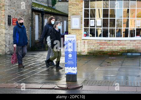 Cambridge, Großbritannien, 19-12-2020. Schilder auf dem öffentlichen Weg, die Menschen darauf hinweist, Abstand zu halten, während Sie einkaufen, Stockfoto