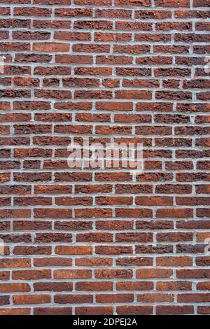 Eine vertikale Aufnahme von einem schönen roten Backstein Wand Hintergrund Textur Stockfoto