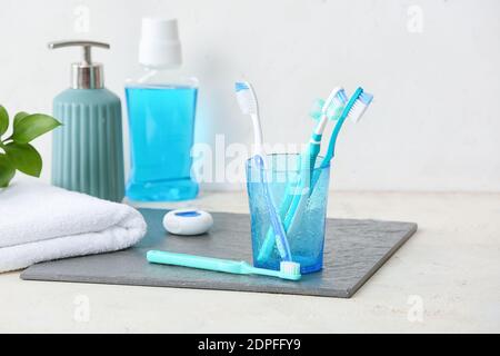 Halter mit Zahnbürsten auf Tisch im Badezimmer Stockfoto