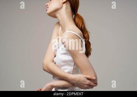 Frau T-Shirt bewegt ihre Hand auf die Seite Ellbogen Emotion Schmerzen Stockfoto