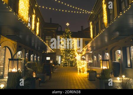 Christmas decoration in Vilnius, Lithuania, lights and night background with Rudolph the Red-Nosed Reindeer and Christmas tree in a open air market Stock Photo