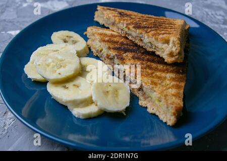 Toasts mit Schokolade und Banane auf einem blauen Teller Stockfoto