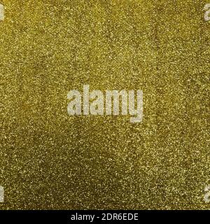 Golden Glitter Hintergrund. Glänzende, abstrakte Stauboberfläche. Schimmernde Hologramm Kristallstruktur. Der Urlaub glänzt vor dem Hintergrund. Stockfoto