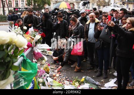 Menschen hinterlassen Blumen entlang einer Bahnschnur in der Nähe des Bataclan-Theaters im 11. Bezirk von Paris am 14. November 2015 wurden nach den Terroranschlägen in Paris am 13. November mindestens 129 Menschen getötet und 352 weitere verletzt - davon 99 in kritischem Zustand. Foto von Somer/ABACAPRESS.COM Stockfoto