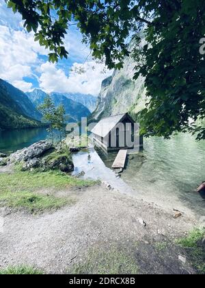 Eine vertikale Aufnahme einer Flusshütte in einem schönen Bergwald an einem bewölkten Tag Stockfoto