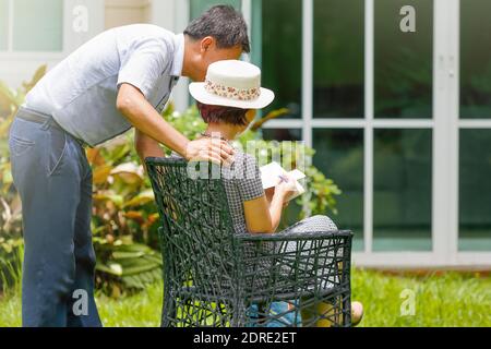 Asiatische mittleren Alters paar sitzen und entspannen im Hinterhof Stockfoto