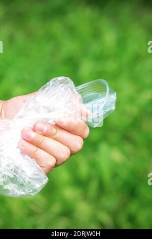 Die Person hält gebrauchte zerknitterte Plastikmüll in der Hand. Konzept für Umweltprobleme. Stockfoto