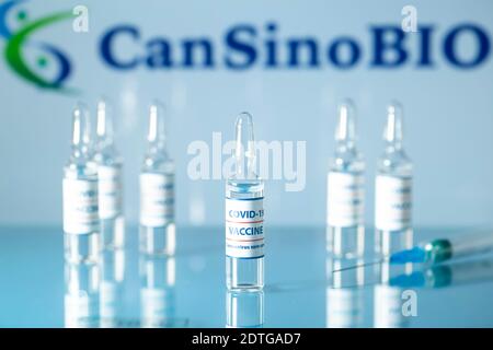 CanSinoBIO chinese vaccine against COVID-19. Glass medical vials with liquid on the background Can Sino Bio company logo. Ampoules with coronavirus va Stockfoto