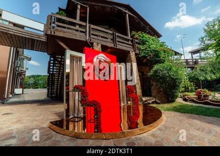 Hochzeitsdekor. Der Bereich für die Hochzeitszeremonie im Hinterhof ist mit roten Rosen-Blumenarrangements dekoriert. Stockfoto