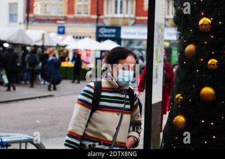 Cambridge UK, 22-12-2020,Erwachsene tragen Gesichtsmaske geht vorbei an Weihnachtsbaum Stockfoto