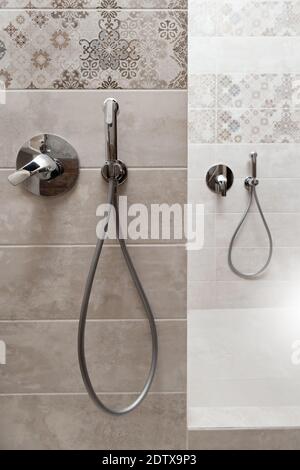 Hygienische Dusche und Wasserhahn in die Wand eingebaut. Stockfoto