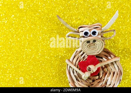 Ochse mit rotem Herz auf gelbem Hintergrund mit Funkeln. Weihnachten und Neujahr Hintergrund. Symbol des Jahres. Valentinstag. Speicherplatz kopieren Stockfoto