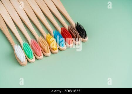 Ein Set umweltfreundlicher antibakterieller Zahnbürsten aus Bambusholz auf hellgrünem Hintergrund. Trends im Bereich Umweltschutz. Stockfoto