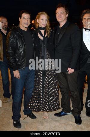 John Travolta, Uma Thurman, Quentin Tarantino bei einer Vorführung am Strand, die anlässlich des 20-jährigen Jubiläums von Quentin Tarantinos Film 'Pulp Fiction' im Rahmen der 67. Filmfestspiele von Cannes am 23. Mai 2014 in Cannes, Frankreich, stattfand. Foto von Lionel Hahn/ABACAPRESS.COM Stockfoto