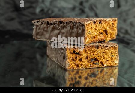 Honigkuchen werden mit Schokolade überzogen. Die Kuchenstücke werden pro Idin gestapelt. Hintergrund für Text Stockfoto
