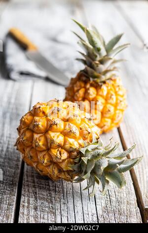 Reife Baby Ananas. Mini Ananas auf Holztisch. Stockfoto