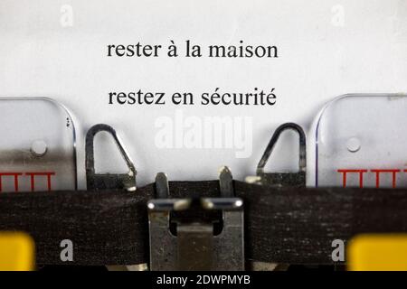 Rester à la maison, restez en securite ( zu Hause bleiben, sicher bleiben) geschrieben auf einer alten Schreibmaschine Stockfoto