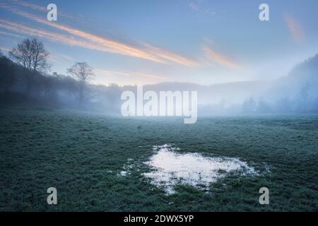 Gefrorene Überschwemmungswasserpfütze am Fluss Wye bei Brockweir. Stockfoto