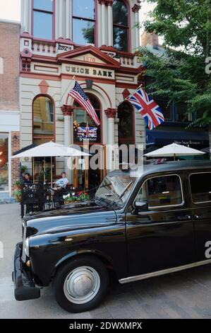 Authentisches schwarzes Londoner Taxi vor dem Union Jack Pub und Restaurant im 1870 Union Bank Gebäude, Altstadt, Winchester, Virginia, USA geparkt Stockfoto