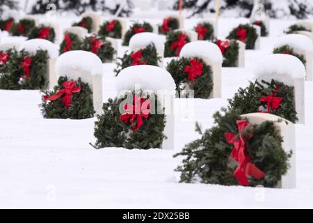 Anchorage, Vereinigte Staaten Von Amerika. Dezember 2020. Tausende von Kränzen auf dem Grab eines gefallenen Dienstmember auf dem schneebedeckten Fort Richardson National Cemetery während Kränze in ganz Amerika 18. Dezember 2020 in der Nähe von Anchorage, Alaska. Kränze in ganz Amerika sollen gefallene Dienstmitglieder während der Weihnachtszeit ehren und daran erinnern. Quelle: Planetpix/Alamy Live News Stockfoto