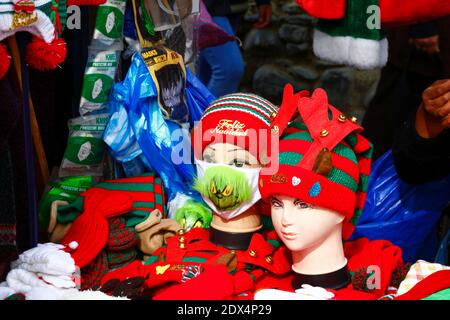 23. Dezember 2020, LA PAZ, BOLIVIEN: Detail eines Straßenstandes, der Elfhüte und Grinch Gesichtsmasken auf einem Weihnachtsmarkt verkauft. Gesichtsmasken mit dem Grinch und anderen Weihnachtsthemen sind ein neues Design in den Märkten als Folge der covid 19 Coronavirus Pandemie. Stockfoto