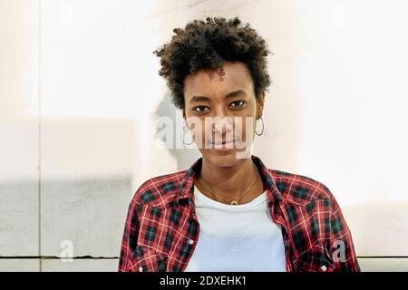 Selbstbewusste junge Afro Hipster gegen weiße Wand Stockfoto