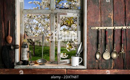 rustic farmer's kitchen with a view of the landscape through a wooden window Stock Photo