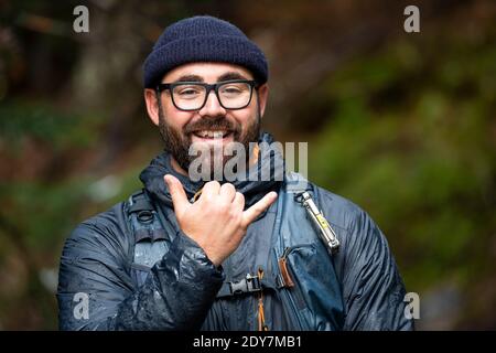 Portrait in der Natur von aufgeregt bärtigen Mann in Hut und Brille und Lächeln Stockfoto
