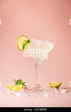 Cocktail margarita garniert mit Limette und Minze auf rosa Hintergrund Stockfoto