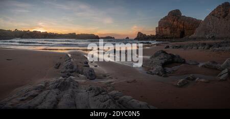 Ein schöner Panoramablick auf den Strand von Portio bei Sonnenuntergang in Liencres, Kantabrien Stockfoto