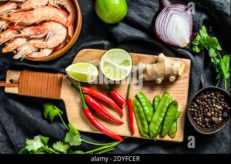 Zutaten zum Kochen Tom Kha Gai. Thailändische Hühnersuppe in Kokosmilch. Schwarzer Hintergrund. Draufsicht Stockfoto