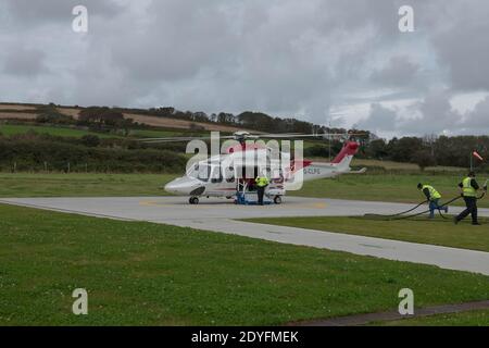 Der Hubschrauber am Penzance Heliport wird betankt und für den Abflug vorbereitet, um Passagiere nach Tresco auf den Scilly-Inseln, Cornwall, England, Großbritannien, zu bringen Stockfoto