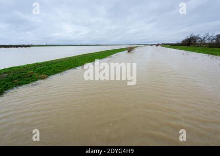 Sutton Gault Cambridgeshire, Großbritannien. Dezember 2020. Der Fluss Great Ouse hat es Ufer auf der New und Old Bedford Ebenen nach den jüngsten starken regen, die Überschwemmungen entlang der Ouse Valley verursacht hat platzen. Die alten und neuen Bedford-Ebene Drainage-Kanäle sind die wichtigsten Drainage-System für die Fens und East Anglia Wasser in die Wash und Nordsee in Norfolk. Straßen sind gesperrt, der Wasserstand ist hoch und es wird mehr Starkregen vorhergesagt. Kredit: Julian Eales/Alamy Live Nachrichten Stockfoto