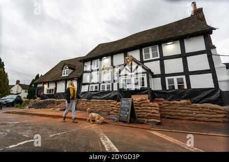 Severn Stoke, Worcestershire, Großbritannien. Dezember 2020. Das Rose and Crown Pub in Severn Stoke in Worcestershire hat Sandsäcke als Hochwasserschutz. Die Kneipe überflutet die meisten Jahre, als die nahe gelegenen Flüsse Severn und Teme ihre Ufer sprengen. Proprieter Andrew Goodall hat vor kurzem die Kneipe übernommen und Tausende für den Hochwasserschutz ausgegeben. Kredit: Peter Lopeman/Alamy Live Nachrichten Stockfoto