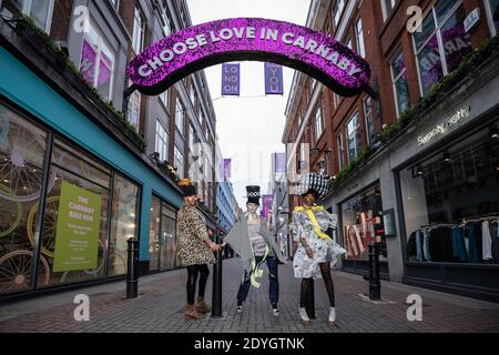 London, Großbritannien. Dezember 2020. Die Models nehmen an einer farbenfrohen Boxing Day Flashmob Modenschau Teil, bei der der Designer Pierre Garroudi die leeren Straßen des West End ausnutzt. Kredit: Guy Corbishley / Alamy Live Nachrichten Stockfoto