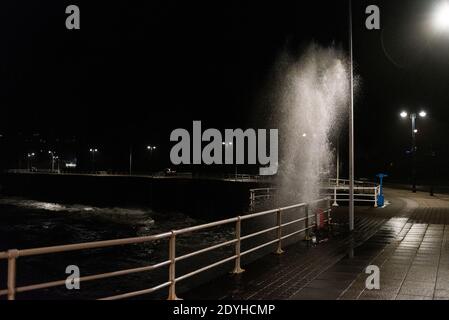 Sturm Bella stürzt am Abend des zweiten Weihnachtsfeiertags bei einer 4.2 Meter hohen Enge gegen die Aberystwyth Promenade. Stockfoto