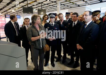 Frankreichs Präsident Francois Hollande (R) hört einem Beamten des Flughafens Roissy am 18. April 2013 in Roissy-en-France, außerhalb von Paris, Frankreich, während eines Besuchs auf dem Flughafen Roissy mit dem französischen Innenminister Manuel Valls (2ndR). Foto von Kenzo Tribouillard/Pool/ABACAPRESS.COM Stockfoto