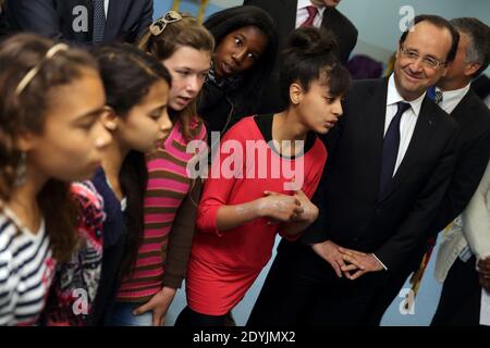 Frankreichs Präsident Francois Hollande hört einer Gruppe von Schülern zu, als er am 30. April 2013 eine Schule in Les Mureaux, einem Vorort von Paris, besucht. Foto von Philippe Wojazer/Pool/ABACAPRESS.COM Stockfoto