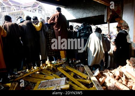 26. Dezember 2020: Kashmiri-Leute bewerten das beschädigte Wohnhaus im Dorf Kanigam im Bezirk Shopian, südlich von Srinagar, indisch verwaltetes Kaschmir am 26. Dezember 2020. Bei einem nächtlichen Treffen wurden zwei lokale kashmiritische Millitanten getötet und zwei indische paramilitärische Truppen verletzt. Quelle: Muzamil MATtoo/IMAGESLIVE/ZUMA Wire/Alamy Live News Stockfoto