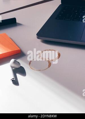 Ein Desktop mit Laptop-Kaffee Flecken bedeckt und Post it Hinweise Stockfoto