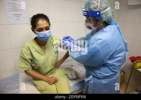 Bukarest, Rumänien. Dezember 2020. Ein medizinisches Personal erhält am 27. Dezember 2020 in einem Krankenhaus in Bukarest, Rumänien, einen Schuss des Impfstoffes COVID-19. Quelle: Gabriel Petrescu/Xinhua/Alamy Live News Stockfoto