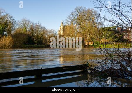 Eton, Windsor, Berkshire. Dezember 2020. Hohe Wasserstände in der Themse fließen an der Eton College Chapel vorbei. An der Themse gibt es einen Hochwasseralarm für Windsor, Eton und Maidenhead. Der Wasserstand an der Themse ist infolge der starken Regenfälle flussaufwärts gestiegen. Daher ist damit zu rechnen, dass sich die Überschwemmungen von Straßen, Wegen und Ackerland auch heute fortsetzen werden. Der Jubilee River ist derzeit aufgrund von Wartungsarbeiten nicht voll in Betrieb, wird aber im Fall eines weiteren Anstiegs betrieben. Die Umweltbehörde geht davon aus, dass die Flußstände in den kommenden Tagen hoch bleiben und als Wasser weiter steigen werden Stockfoto