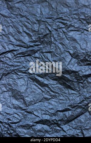 Hintergrund aus zerknittertem schwarzem oder grauem Papier. Stockfoto