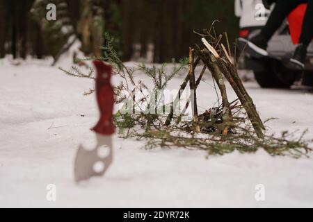 Touristenmesser und Lagerfeuer im Winterwald. Touristen in Ruhe Stockfoto