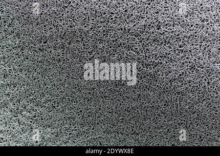 Textur von grauen Kunststoff-Teppich Nahaufnahme. Gerippte Gummi-Textur. Stockfoto