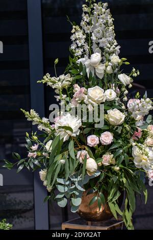 Beeindruckendes floristisches Bouquet von weißen Rosen und Delphinium - grün Drehen Stockfoto