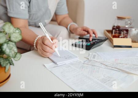 Frau prüft unbezahlte Rechnungen Stockfoto
