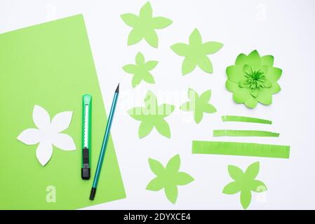 Erstellen von Papierhandarbeiten für Muttertag oder Geburtstag. Schritt. Lernprogramm. Papierblume für Mama auf weißem Tisch. Einfache Kinder Handwerk Idee. Draufsicht Stockfoto